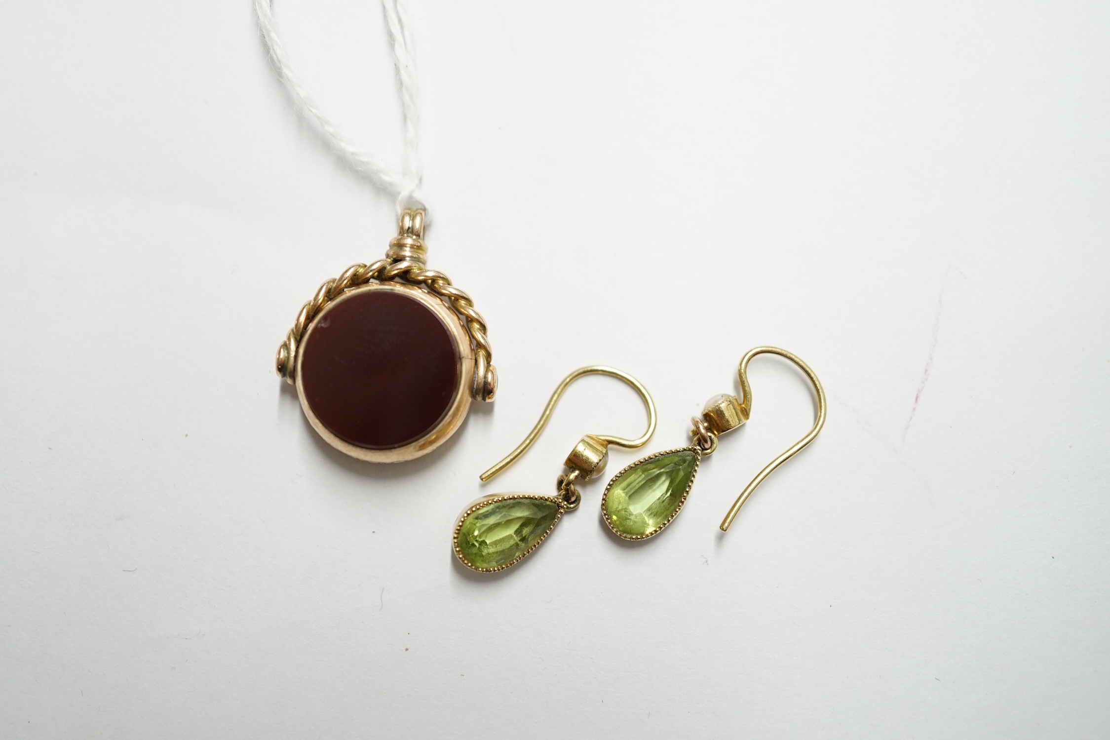 A pair of yellow metal peridot? and seed pearl set drop earrings, 11mm, together with a late Victorian 9ct gold, carnelian and bloodstone set spinning fob. Condition - fair